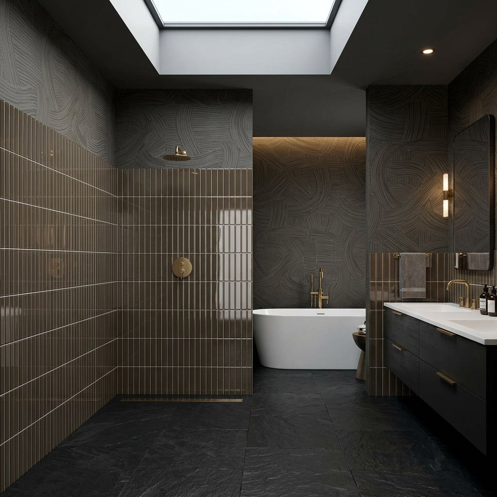 Interstyle 240 Rocky 3" × 12" back-painted glass tile installed in a luxurious modern bathroom, with stacked vertical tiles surrounding a walk-in shower, bathtub, and vanity. Dark finishes, a skylight, and warm lighting highlight the tile’s rich Rocky colour and reflective glass surface.